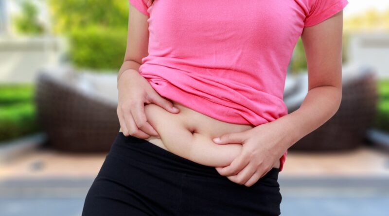 A woman holding herself on her stomach